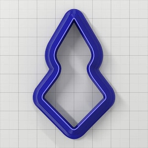 May include: A blue plastic cookie cutter shaped like a stylized Christmas tree.