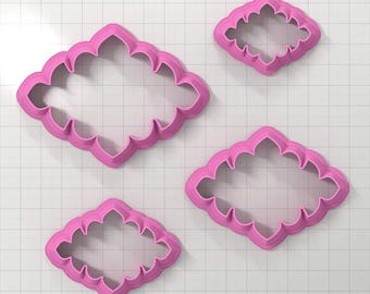 May include: Set of three pink plastic cookie cutters in different sizes, each with a decorative, ornate, diamond-shaped design.