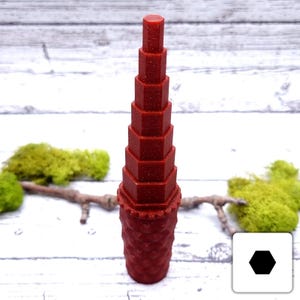 May include: A red, geometric stacking tower made of plastic. The tower is made up of 10 pieces, each with a different number of sides. The tower is about 25 cm tall.