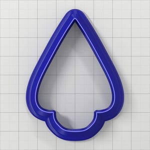 May include: A blue plastic cookie cutter shaped like a Christmas tree with a rounded top and a scalloped bottom.