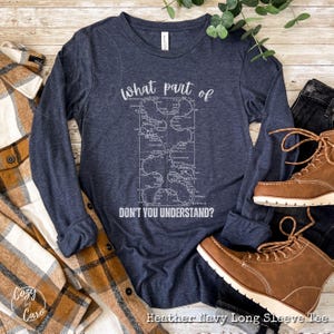 May include: Heather navy blue long sleeve t-shirt with a white graphic of a maze with the text "What part of don't you understand?" printed on the front.