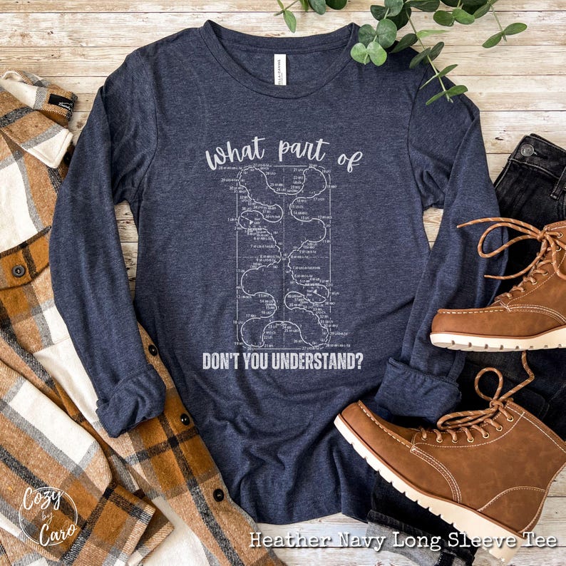 May include: Heather navy blue long sleeve t-shirt with a white graphic of a maze with the text "What part of don't you understand?" printed on the front.