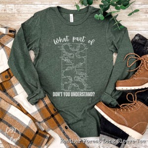 May include: A long-sleeved heather forest green t-shirt with a white graphic of a map and the text "What part of don't you understand?"