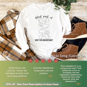 May include: White long-sleeve t-shirt with a black and white graphic of a map with the text "what part of DON'T YOU UNDERSTAND?" printed on it. The shirt is displayed on a wooden surface with a plaid shirt and brown boots.
