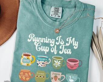 May include: Light green Comfort Colors t-shirt with the phrase "Running Is My Cup of Tea" and illustrated teacups. Each teacup has a different design and word, including "Sprint," "Endurance," and "Recovery."