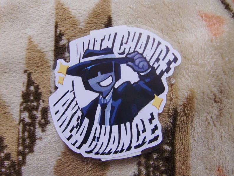 Puede incluir: Una pegatina con un personaje de dibujos animados con traje y sombrero, con el texto "TAKE A CHANCE" en una fuente estilizada. El personaje es azul con fondo blanco y estrellas amarillas.