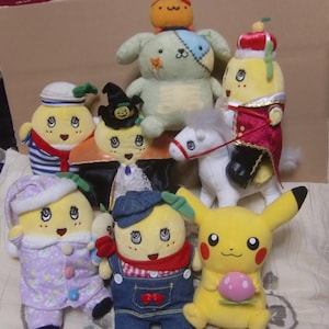 May include: A collection of plush toys, including a yellow Pikachu, a white horse, a green dog, and several yellow characters wearing different costumes. The yellow characters are all wearing different costumes, including a sailor outfit, a vampire costume, a cowboy outfit, and a sleepwear outfit.