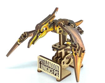 May include: A wooden Pteranodon Longiceps model with articulated wings and body. The model is made of light brown wood with yellow and orange accents. The base features the name "Pteranodon Longiceps".