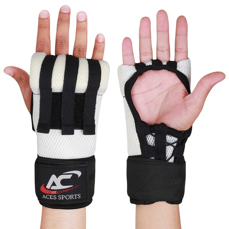 May include: A pair of white and black padded hand wraps with a velcro wrist strap. The wraps have a mesh design and the wrist strap has the logo "ACES SPORTS" in red and silver.