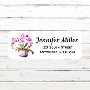 May include: A white return address label with a pink orchid plant illustration. The label has the text "Jennifer Miller", "123 South Street", and "Anywhere, NH 01234".