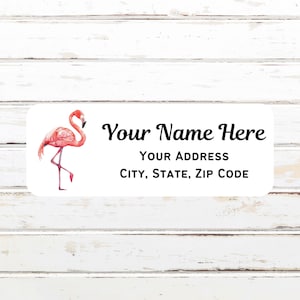 May include: A white label with a pink flamingo illustration. The label says "Your Name Here" and "Your Address City, State, Zip Code".