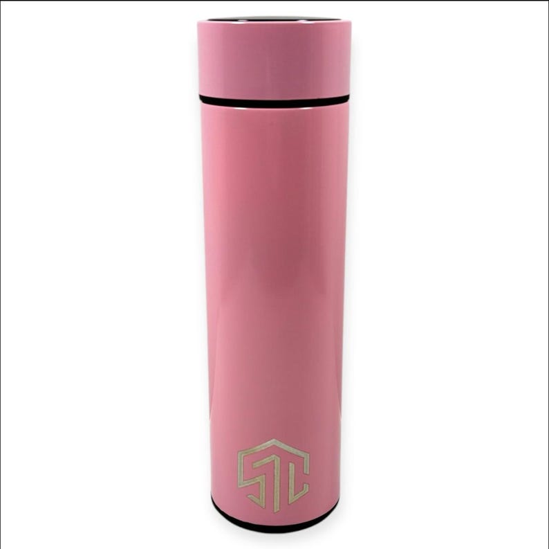 May include: A pink insulated water bottle with a black base and a matching pink lid. The bottle has a silver logo near the bottom. The bottle is cylindrical and appears to be made of metal.