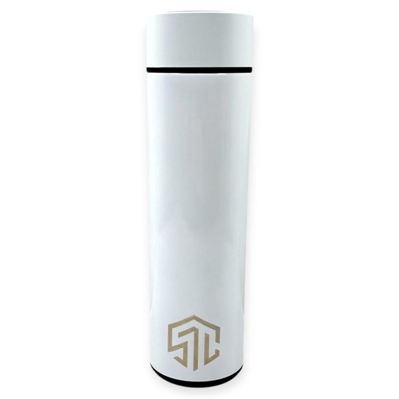 May include: A white insulated water bottle with a black band near the top and a white cap. The bottle has a geometric logo in a light brown color near the bottom. The bottle is cylindrical.
