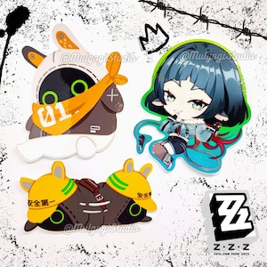 May include: Three colourful stickers featuring cartoon characters. The first sticker is a white bunny with a black head and orange bandana. The second sticker is a blue-haired girl with a red scarf. The third sticker is a black and yellow robot with a green stripe. The stickers have the text "@Mulgogi Studio" and "Z.Z.Z. zenLess zone zero" on them.