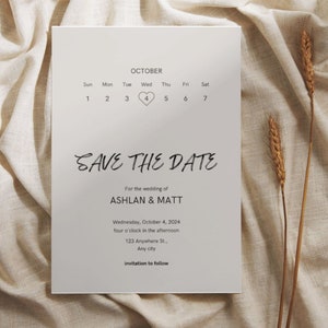 May include: A save the date card with a calendar featuring a heart on October 4th. The card is for the wedding of Ashlan and Matt, taking place on Wednesday, October 4, 2024 at four o'clock in the afternoon. The address is 123 Anywhere St., Any city. The text "invitation to follow" is at the bottom of the card.