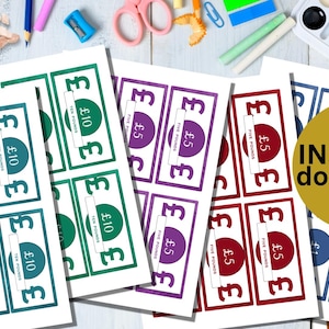 May include: A set of printable money game tokens in various colors, including green, purple, red, blue, and brown. Each token features a circle with a denomination of either £5 or £10. The text "Free Points" is printed on each token. The tokens are designed for a money game or activity.