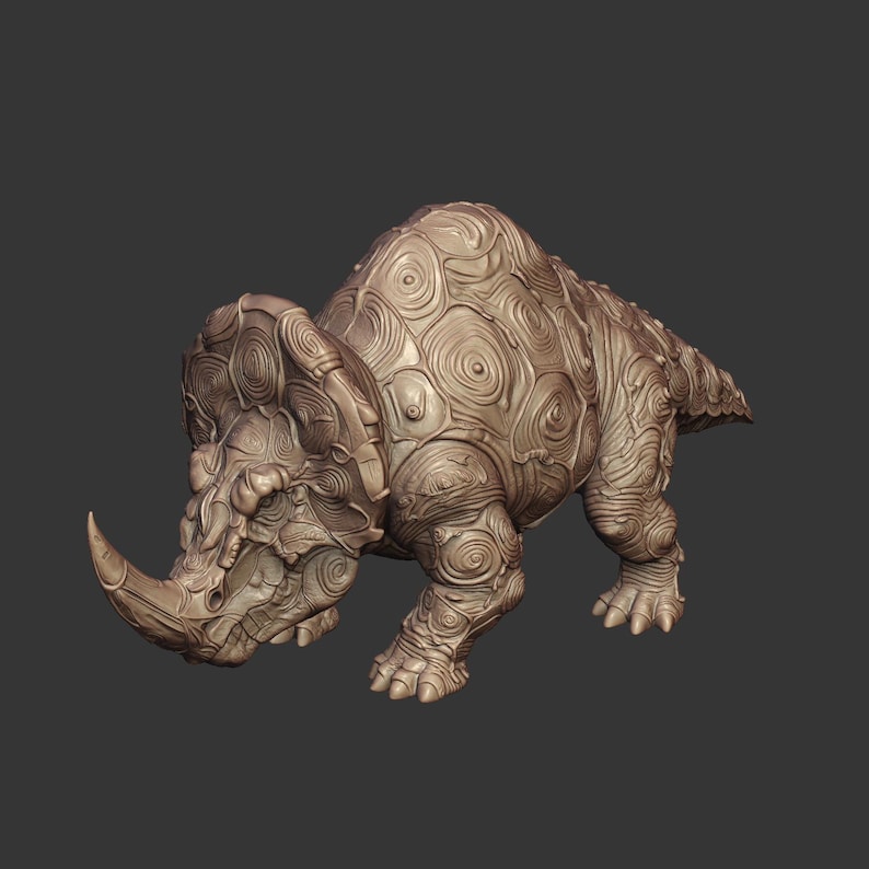 May include: A tan-colored triceratops figurine featuring a detailed surface texture composed of numerous raised, swirling circular patterns across its entire body, including the large frill, head, legs, and back, ending in a pointed tail.