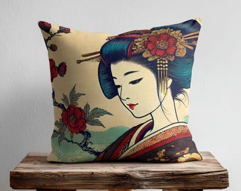 May include: A square throw pillow featuring a printed illustration of a person with dark blue hair styled with gold hairpins and a large red flower. The person wears a dark patterned garment, set against a cream background with red flowers.