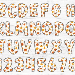 May include: A set of alphabet letters and numbers with a pumpkin and striped pattern. The letters and numbers are outlined in black and have a stitched look.