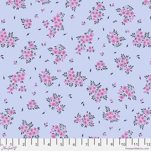 May include: A light blue fabric with a repeating pattern of pink floral clusters and dark green leaves. The fabric has a ruler along the bottom edge, with the text "Free Spirit Fabrics" and "freespiritfabrics.com".