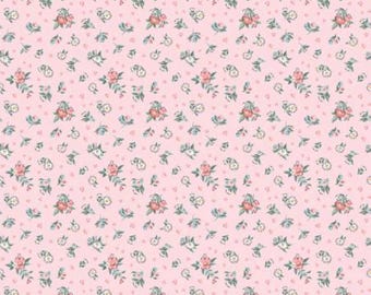 May include: A repeating pattern of small pink roses, white flowers, and green leaves on a light pink background. The design includes tiny pink hearts scattered throughout. This floral pattern is suitable for fabric or wallpaper.