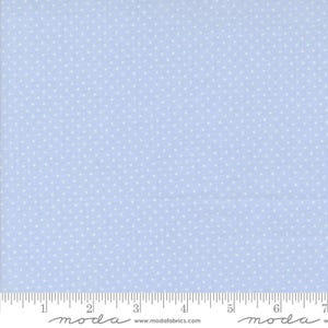 May include: Light blue fabric with a repeating pattern of small white polka dots. The fabric is marked with a ruler along the bottom edge, with the word "moda" printed at the bottom.