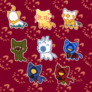May include: A collection of eight stylised cat-shaped stickers featuring various designs, including a white and gold cat, a yellow cat with red markings, a white cat with a cross, a green cat with a wide mouth, a white cat, and three robotic-style cats.