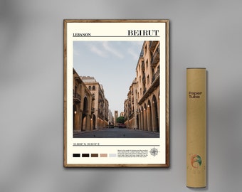 May include: A poster with a photograph of a street in Beirut, Lebanon. The poster has a brown wooden frame and includes the city's name, coordinates, and a compass rose. The poster is printed on white paper and has a vintage newspaper style.