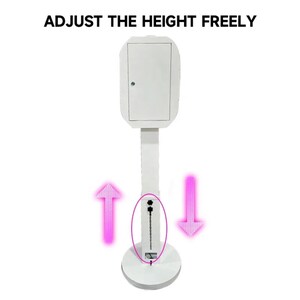 May include: White photo booth stand with a white rectangular box on top. The stand has a telescoping pole that can be adjusted up and down to change the height of the booth. The pole is marked with arrows indicating the direction to adjust the height.