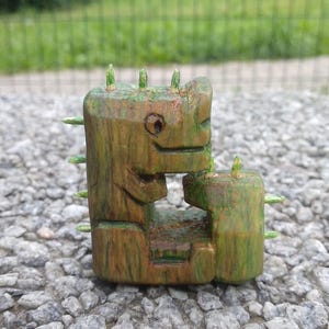 Wooden dinosaur. Figure of a dinosaur. Dinosaur statuette. Carved dinosaur.