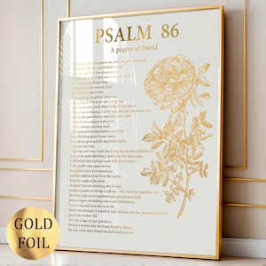Könnte beinhalten: Gerahmter Goldfoliendruck mit Psalm 86, einem Gebet Davids, und floralen Illustrationen. Der Text ist goldfarben auf cremefarbenem Hintergrund, in einem goldenen Rahmen. Das Design zeigt detaillierte Blumen.