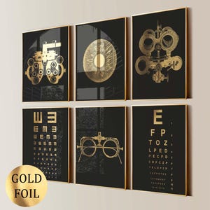 May include: Six framed wall art prints with gold foil accents on a black background. The prints feature eye exam charts, eye diagrams, and optometry tools. The words "GOLD FOIL" are printed on a gold foil circle.