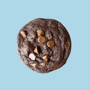 May include: A dark chocolate chip cookie with a slightly crispy texture and a rich, dark chocolate flavor.