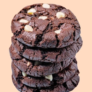 May include: A stack of four chocolate chip cookies with white chocolate chips. The cookies are dark brown and have a slightly crispy texture.