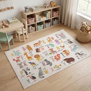 May include: A colorful alphabet rug with animal illustrations, including a giraffe, lion, and zebra. The rug features the letters of the alphabet and is designed for a child's room. The rug is rectangular and placed on a wooden floor.