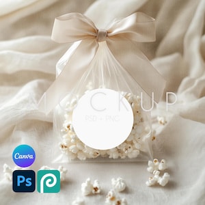 May include: A clear plastic bag filled with white popcorn tied with a beige satin ribbon and a white circle label with the text "PSD + PNG".