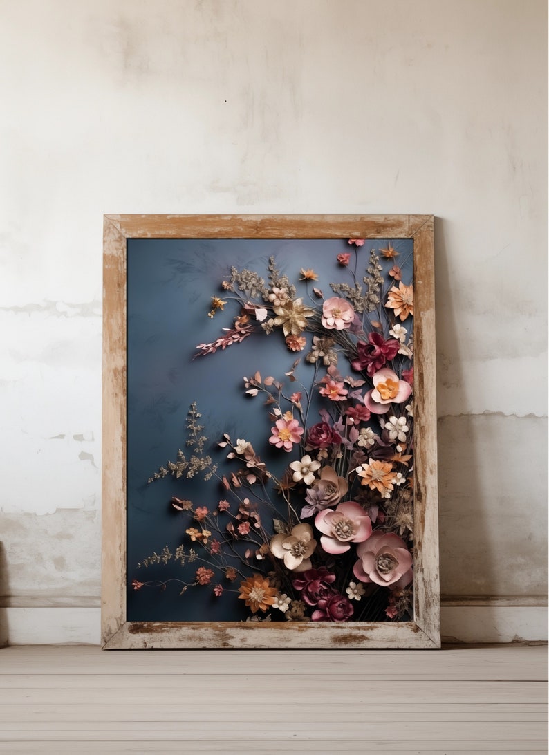 May include: A framed artwork featuring a 3D floral arrangement with pink, red, and gold paper flowers on a blue background.