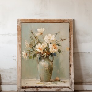 May include: A framed painting of a bouquet of white flowers in a green vase. The flowers are arranged in a loose, natural style, and the vase is a simple, classic design. The background is a soft, muted green.