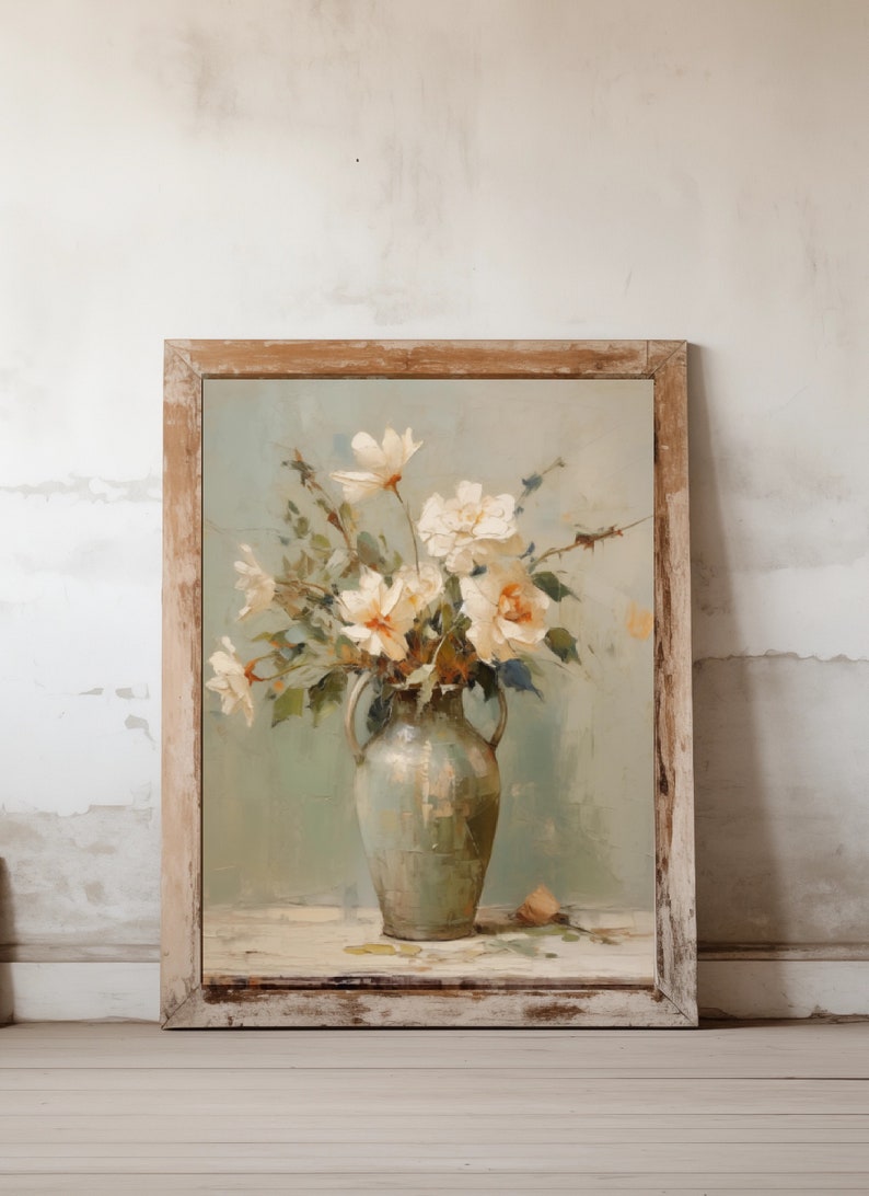 May include: A framed painting of a bouquet of white flowers in a green vase. The flowers are arranged in a loose, natural style, and the vase is a simple, classic design. The background is a soft, muted green.