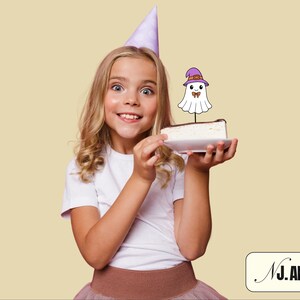 May include: A young person wearing a purple party hat holds a slice of cake topped with a cartoon ghost wearing a witch hat. The cake has a chocolate topping. The image has a light yellow background and the text "NJ. ART" in the bottom right corner.