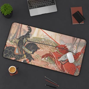 May include: A rectangular desk mat featuring a medieval jousting scene with a black knight on a black horse facing a red knight on a red horse. The mat has a black border and is surrounded by a laptop, a mouse, and other office supplies.