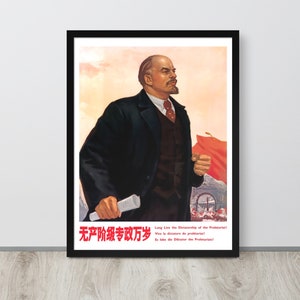 May include: A vintage propaganda poster featuring a portrait of Vladimir Lenin in a black suit and tie, holding a scroll. The poster is in red, white, and black with the text "Long Live the Dictatorship of the Proletariat!" in English and Chinese. The poster is framed in black.