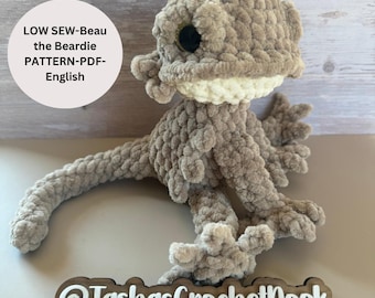 May include: A crocheted bearded dragon plush toy in beige with white accents. The toy is sitting on a wooden surface with a sign that reads "@TashasCrochetNook". The text "LOW SEW-Beau the Beardie PATTERN-PDF-English" is visible in the image.