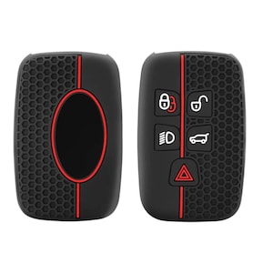 May include: Two black silicone key covers with red accents. The cover on the left has a honeycomb pattern and a red outline around a black oval. The cover on the right has a honeycomb pattern and a red line down the centre. The cover on the right has four buttons with icons for lock, unlock, headlights, and a car. The cover on the right also has a red triangle icon.