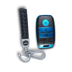 May include: A black leather car key fob cover and matching braided keychain. The key fob has a textured black surface with blue accents and buttons. The keychain has a silver clasp and a car emblem.