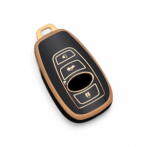 May include: Black car key fob with gold trim and buttons. The buttons have icons for unlock, boot, and panic.