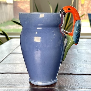 May include: A white ceramic mug with a black handle and the text "But First, Coffee" in a black, handwritten-style font. The mug is likely 11-15 ounces in size, perfect for a morning beverage.