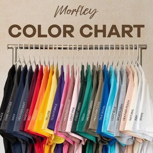 May include: Color chart showing 24 different t-shirt colors, including black, navy, maroon, red, orange, gold, yellow, team purple, charity pink, heather mauve, light pink, forest green, kelly, military green, heather olive, true royal, turquoise, light blue, sports gray, heather peach, natural, ash, and white.