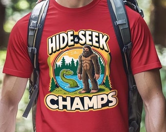 Hide And Seek Champs - Funny Bigfoot and Loch Ness T-Shirt - Humorous Cryptid Graphic Tee - Playful Mythical Creature Shirt - Fun Gift Idea