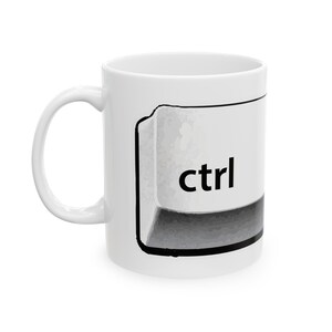 May include: White ceramic mug with a black and white illustration of a computer keyboard key with the word "ctrl" printed on it.
